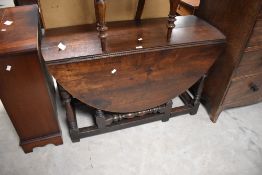 A Victorian oak gate legged dining table, of traditional design with demi-line flaps and block and