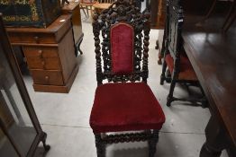 A Victorian carved and stained oak Carolean style dining chair, having a shaped, pierced and