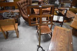 A 19th century oak, brass and cast iron pedestal duet music stand, the opposing rests over the