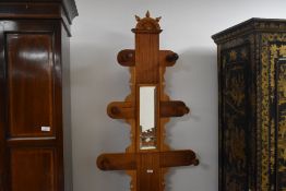 A Victorian walnut and mahogany hall stand, the central mirrored upright issuing graduating coat