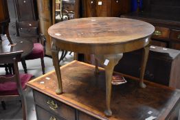 A 1940's walnut circular occasional table with cabriole type supports 42cm x 60.5cm