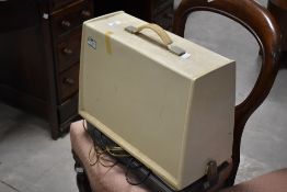A vintage Singer electric sewing machine, with case
