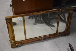A 19th century giltwood over mantel mirror, having three mirror plates enclosed by half columns