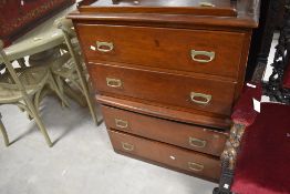 An unusual 1950's stained pine chest of drawers, the rectangular top with shallow gallery and