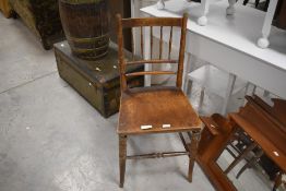 A late Victorian bedroom chair with spindle back and solid seat, seat height 43cm