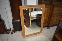 A large rectangular pine framed wall mirror 77cm x 109cm