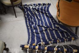 two bamboo, rope and dyed material hammocks, of typical form