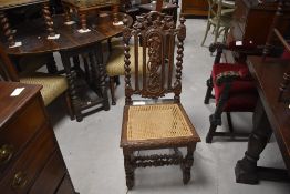 A Victorian carved oak and cane seated dining chair, with Carolean influenced design having