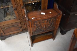 A small late Victorian oak free standing cupboard, having a stipple carved 'Green Man' design