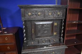 A 19th century Jacobean revival oak credence cupboard, having a moulded and carved cornice above two