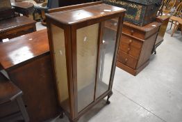 A 1940s glazed walnut display cabinet, with glass shelving 113cm x 58cm x 25cm
