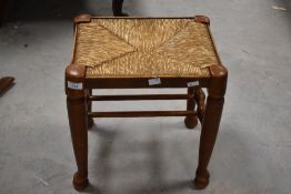 A 20th century string seated stool, with turned supports and stretchers 40cm x 36cm x 29cm
