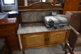 An Edwardian walnut marble topped washstand, the arched back with shaped shelf over the variegated