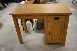 A modern light oak desk, with knee hole section, single drawer and cupboard 80cm x 110cm x 55cm