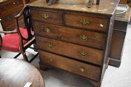 A 19th century oak chest of drawers, of traditional design with shaped brass back plates and bale