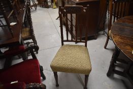 A set of four early 20th Century mahogany rail back dining chairs having Art Nouveau style carved