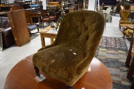 A Victorian deep-buttoned child's nursing style chair, the buttoned back and serpentine fronted seat