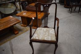 A 20th century mahogany carver armchair, having a concave top rail over a tapering and pierced