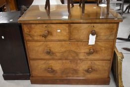A 19th century figured mahogany chest of two short and three long drawers, each with turned wooden