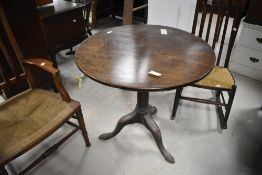 A 19th century mahogany snap top stem table, the circular one piece top above the snap-top action