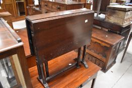A small reproduction mahogany Sutherland type table, with rounded rectangular flaps, turned supports