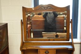 A late 19th/early 20th century Arts & Crafts oak dressing chest, the rectangular mirror plate with