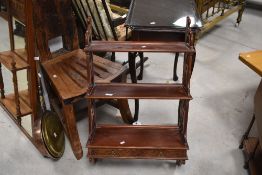 A set decorative mahogany three tier wall shelves, having three moulded tiers over base drawers