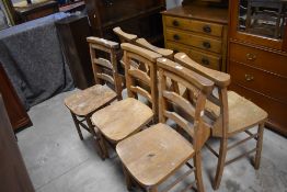 A set of six chapel chairs, of traditional design with book trough to back, seat height 45cm