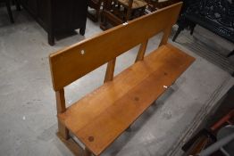 A pair of modern light oak benches, believed to be of ecclesiastical origin, having single planked