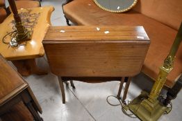 An Edwardian inlaid mahogany Sutherland table, of traditional design with pierced and shaped end