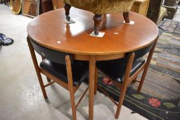 A 1970's McIntosh teak circular dining table and three chairs, 76cm x 114cm, seat height 45cm