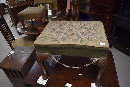 A 19th century mahogany needlework footstool, the rectangular padded top with foliate needlework