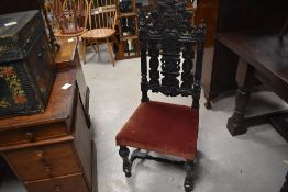 A 19th century carved oak dining chair in the Charles II style with arched, pierced and carve