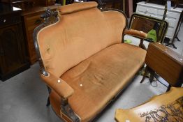 A Victorian inlaid mahogany two piece suite, comprising settee and armchair with carved and inlaid