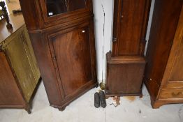 A George III string-inlaid mahogany double corner cupboard, the upper stage with overlapping