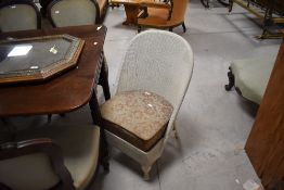 A mid century woven wicker bedroom chair, in the manner of Lloyd Loom, with sprung drop-in seat,