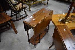 An Edwardian inlaid mahogany Sutherland table, of traditional design with shaped and moulded edge