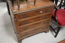 A 19th century design mahogany chest of four cockbeaded drawers, each with shaped and pierced