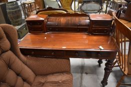 A Victorian mahogany writing table, of rectangular form, the raised superstructure with central