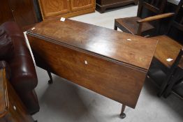 A George III mahogany drop-leaf dining table, of oblong for with hinged leaved and raised on