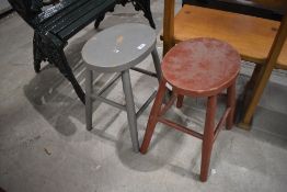 A pair of vintage painted oval seated stools, with spindle legs and stretchers 44cm x 33cm