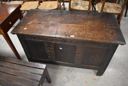 An 18th century oak three-panel coffer, the rectangular top with moulded edge detail opening on ring
