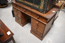 A 19th century pine kneehole pedestal desk, the rectangular top with three frieze drawers on two