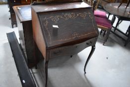 An early 20th century inlaid mahogany bureau de dame, of traditional fall-front design with scrolled