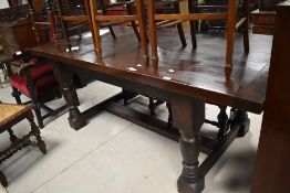 A substantial stained pine refectory type table, the rectangular planked top with cleated ends