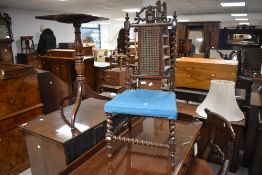 A Victorian oak hall chair, having a carved and pierced crest rail over a central caned panel and