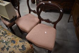A group of three Victorian mahogany balloon back dining chairs, of traditional design with pink fish
