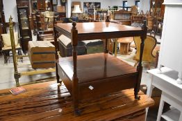 A reproduction mahogany two tier occasional table with base drawer and turned supports 52cm x 44cm