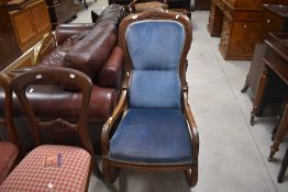 A Victorian mahogany part upholstered low rocking chair with incised detail and padded back and