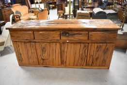A substantial and impressive rustic wooden sideboard, thought to be Australian Jarrah, having an